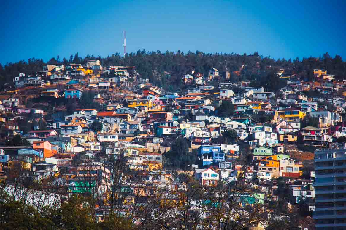 Brightly painted houses stacked up a steep Valparaiso hillside