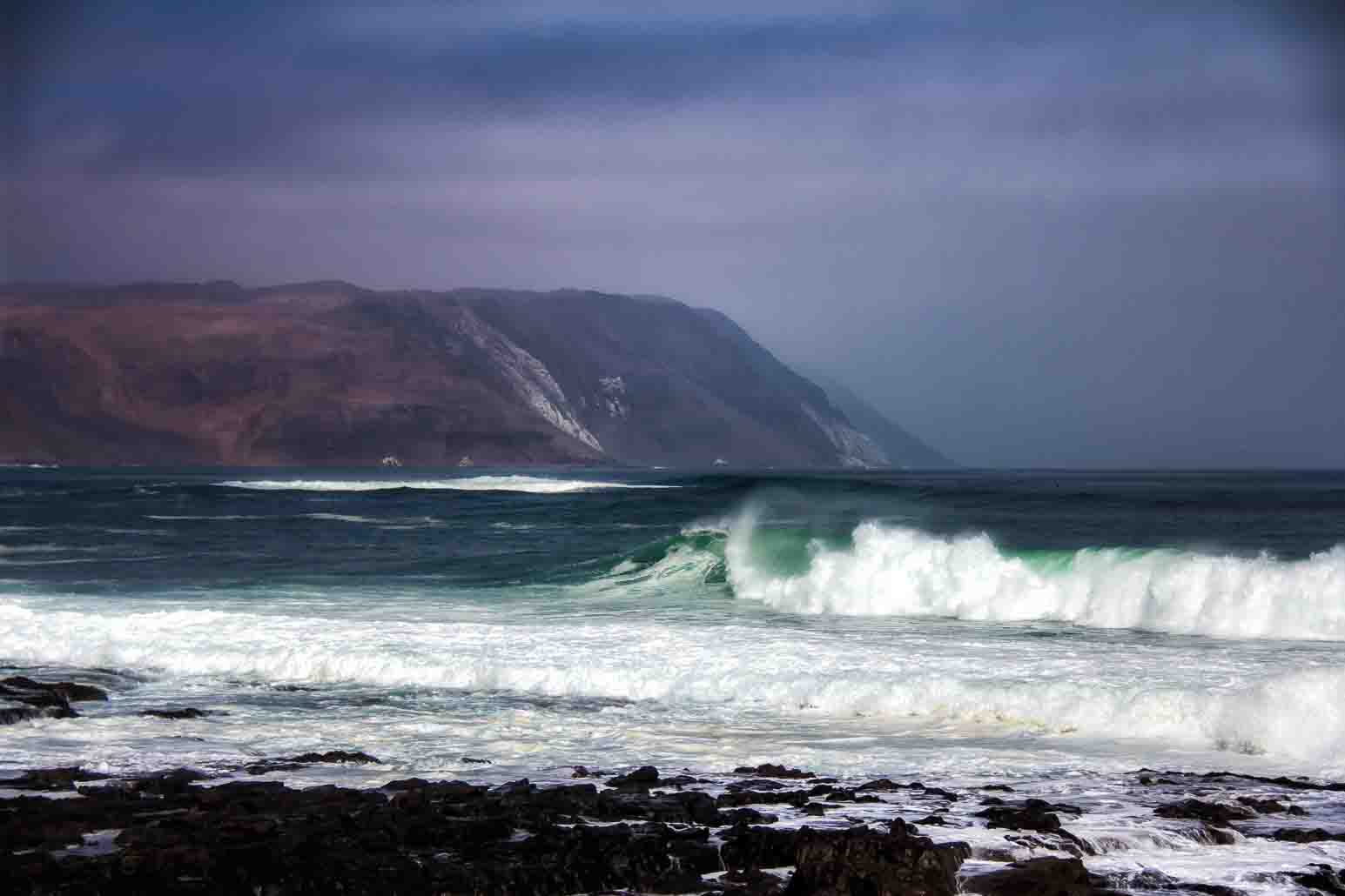 Waves breaking against an empty rocky coast